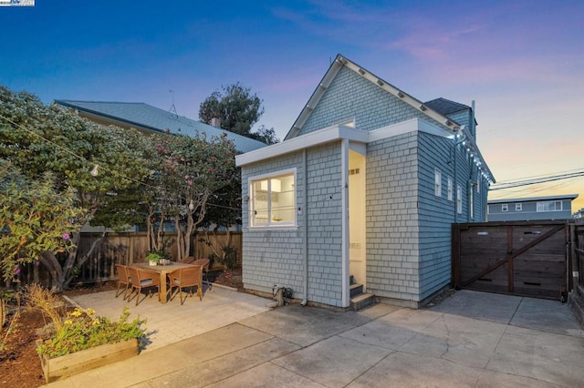 back house at dusk with a patio