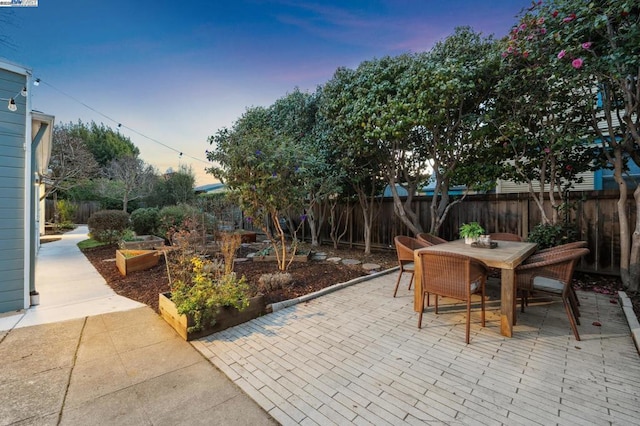 view of patio terrace at dusk