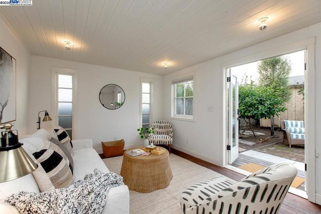 living room featuring hardwood / wood-style flooring and wooden ceiling