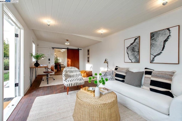 living room with dark hardwood / wood-style flooring, wooden ceiling, and a barn door