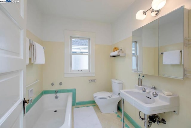 bathroom featuring toilet and a washtub