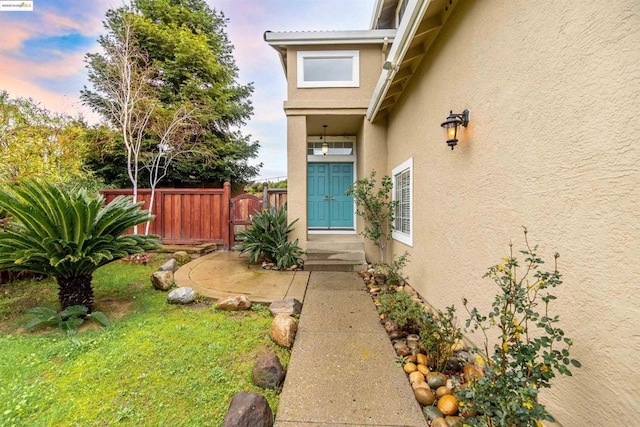 exterior entry at dusk with a yard