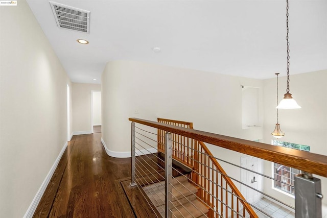 hallway with dark hardwood / wood-style flooring