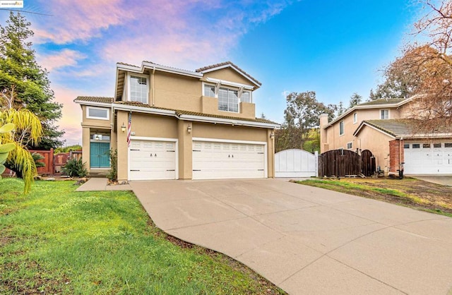 view of front of house with a garage and a yard