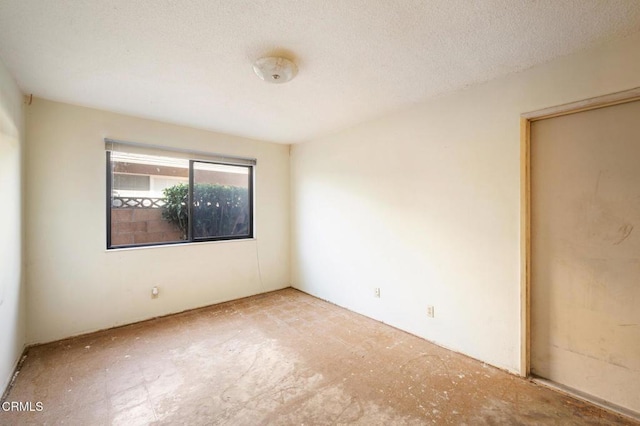 spare room featuring a textured ceiling