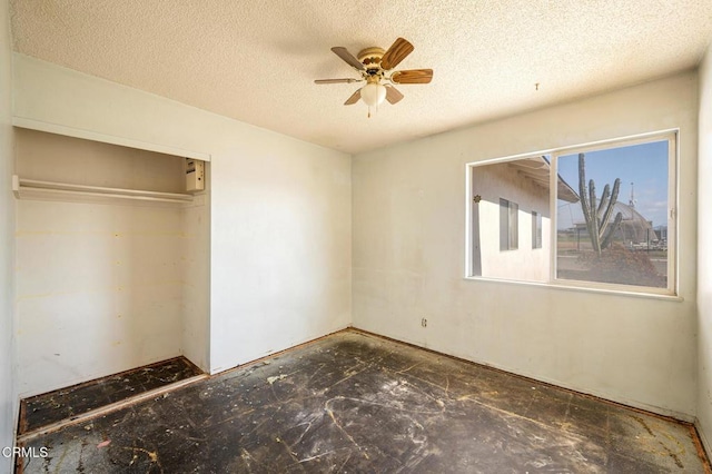 unfurnished bedroom featuring a textured ceiling and a closet