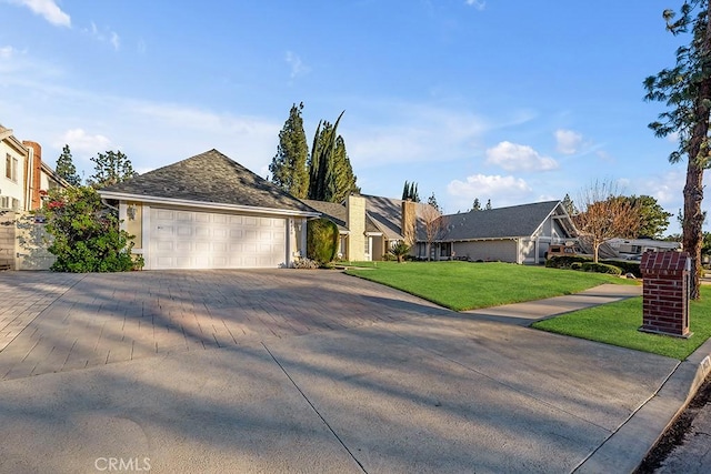 single story home featuring a garage and a front yard