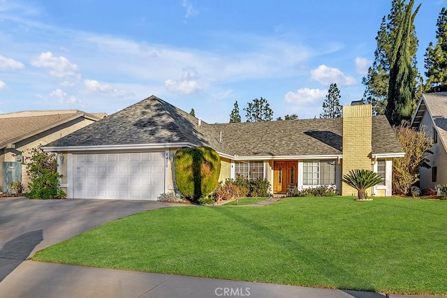 view of front of house with a garage and a front yard