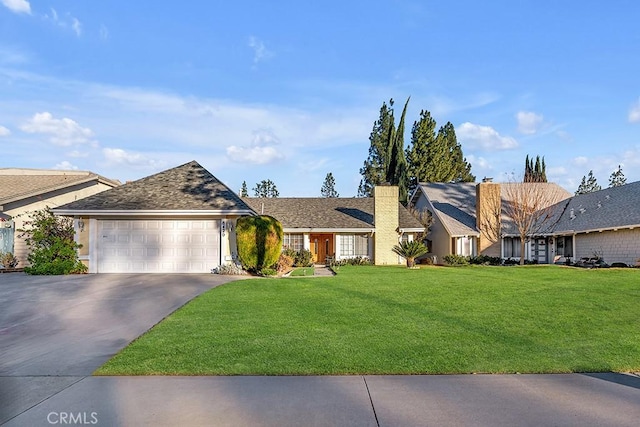 single story home featuring a garage and a front lawn