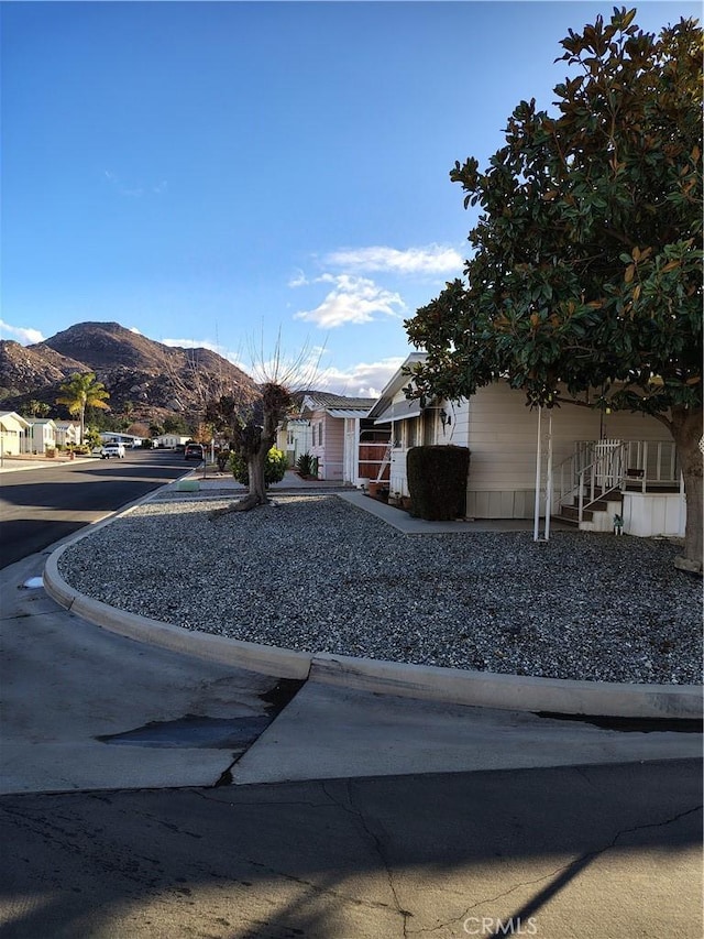 view of front of home with a residential view and a mountain view