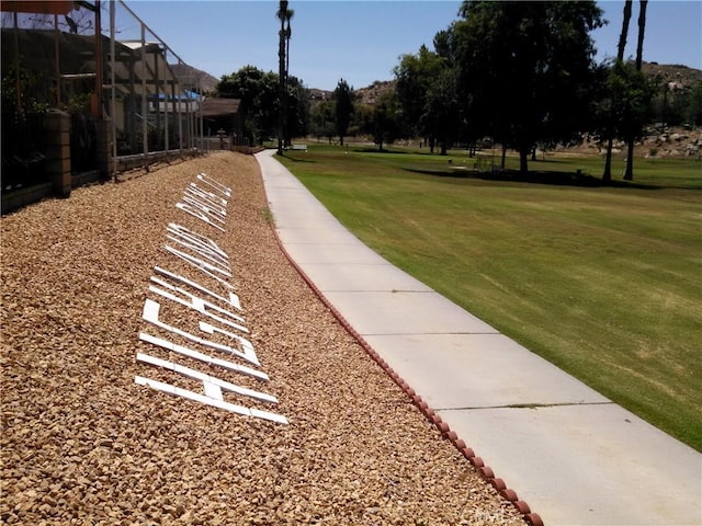 view of property's community with a lawn