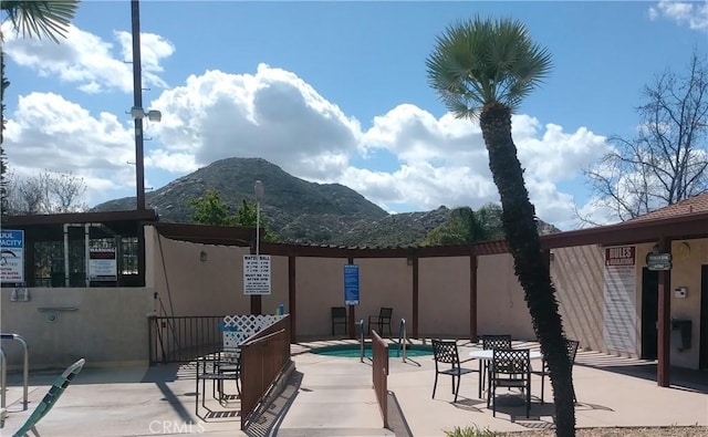 view of patio with a swimming pool and a mountain view