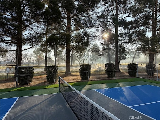 exterior space featuring a tennis court and fence