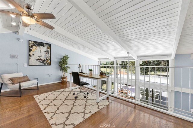 unfurnished office featuring hardwood / wood-style flooring, ceiling fan, and lofted ceiling with beams