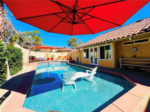 view of pool featuring french doors