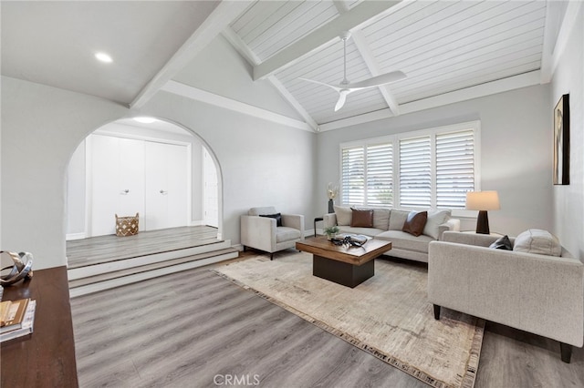 living room with ceiling fan, lofted ceiling with beams, and hardwood / wood-style floors