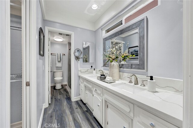 bathroom featuring vanity, hardwood / wood-style floors, and toilet