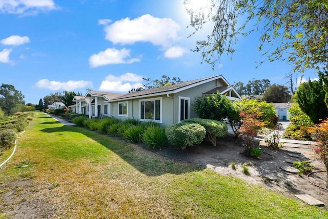 view of property exterior featuring a lawn and stucco siding