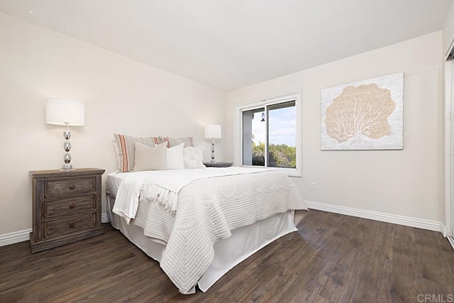 bedroom with dark hardwood / wood-style flooring