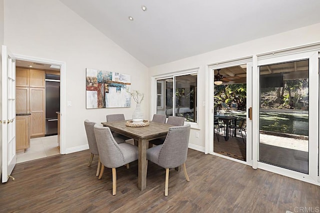 dining space with high vaulted ceiling and dark hardwood / wood-style flooring