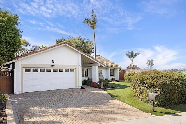 view of front of property featuring a garage and a front yard