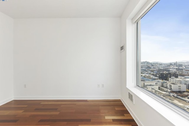 spare room featuring dark hardwood / wood-style floors