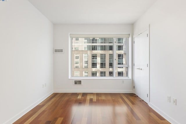 spare room featuring hardwood / wood-style floors