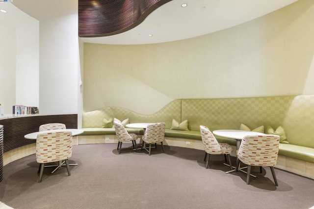 sitting room featuring vaulted ceiling and carpet