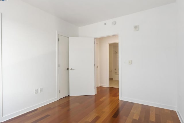 empty room featuring dark hardwood / wood-style flooring