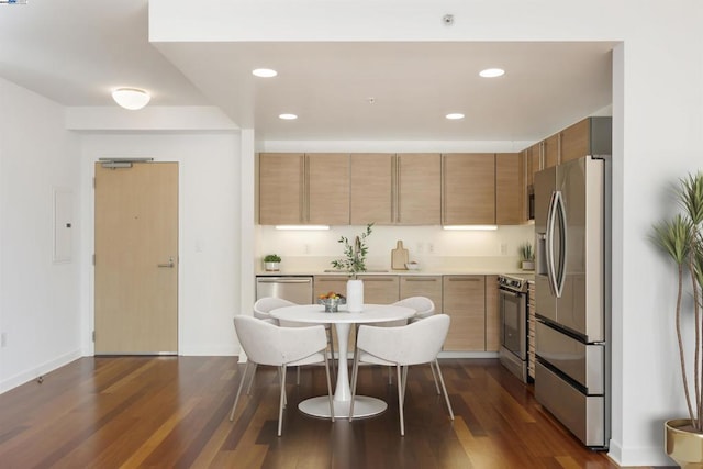 kitchen featuring appliances with stainless steel finishes, dark hardwood / wood-style flooring, and electric panel