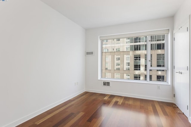 empty room with dark wood-type flooring