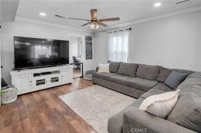 living room with crown molding, dark hardwood / wood-style floors, and ceiling fan