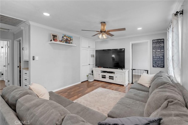 living room with crown molding, ceiling fan, and light hardwood / wood-style flooring