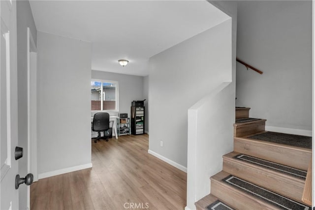 stairway with hardwood / wood-style floors