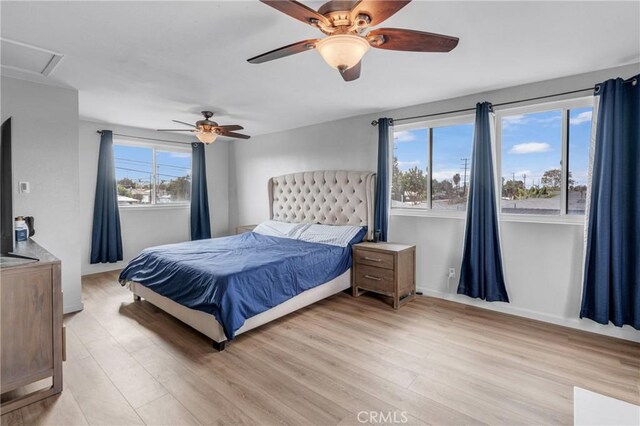 bedroom with ceiling fan and light wood-type flooring