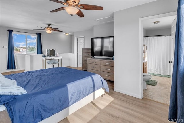 bedroom with ceiling fan, connected bathroom, and light wood-type flooring