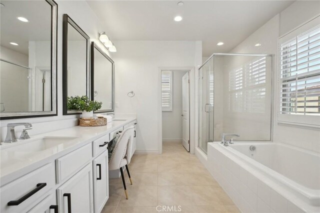 bathroom featuring tile patterned flooring, vanity, separate shower and tub, and a wealth of natural light