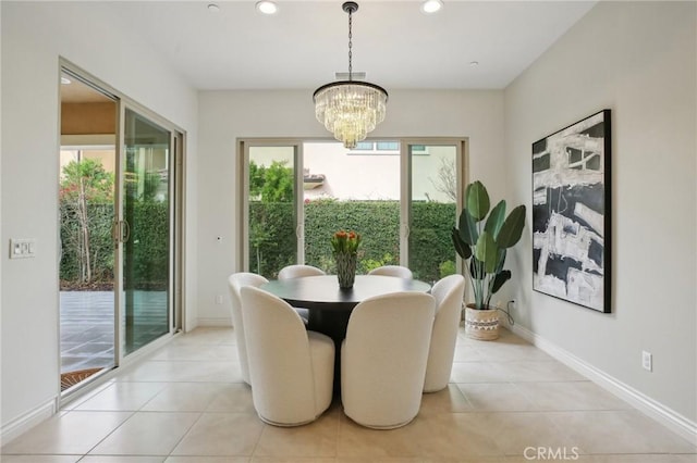 dining space featuring light tile patterned floors and a chandelier