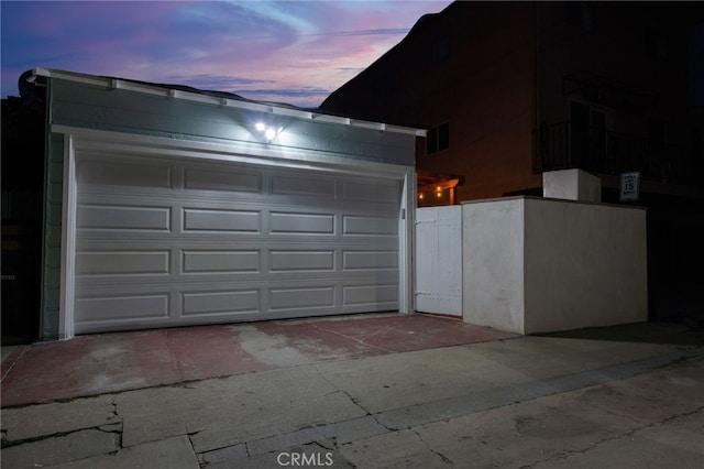 view of garage at dusk