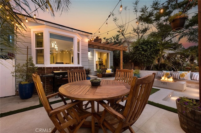 patio terrace at dusk featuring an outdoor living space with a fire pit