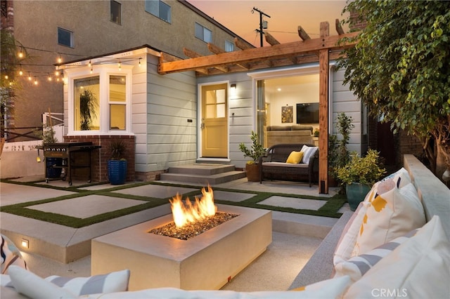 exterior space with an outdoor living space with a fire pit