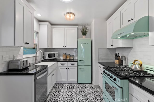 kitchen with white cabinetry, stainless steel appliances, and sink