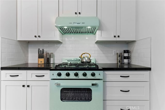 kitchen with tasteful backsplash, white cabinets, ventilation hood, and stove