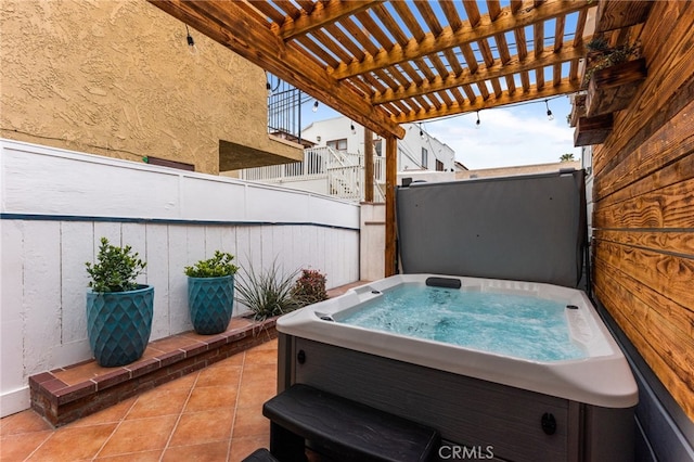 view of patio / terrace featuring a hot tub and a pergola