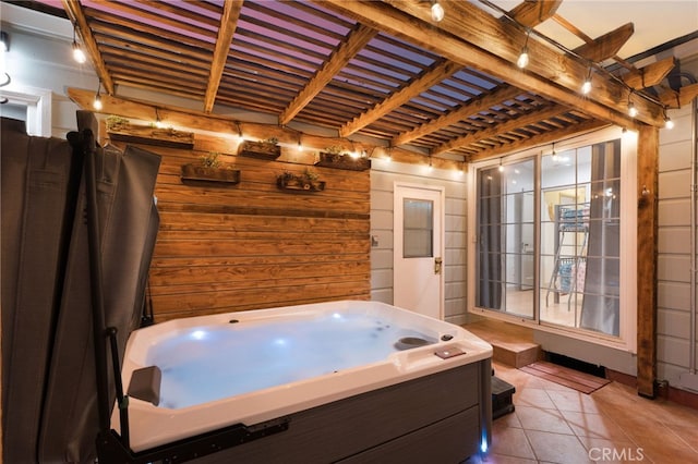 bathroom featuring tile patterned flooring, wooden walls, and beamed ceiling