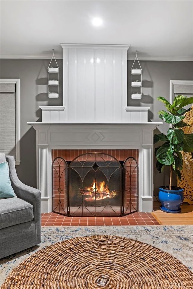 interior details with crown molding and a brick fireplace