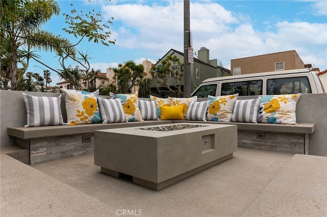 view of patio featuring an outdoor living space with a fire pit