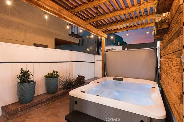 patio terrace at dusk with a hot tub