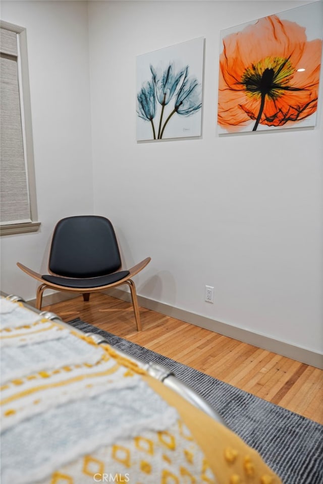 sitting room with wood-type flooring