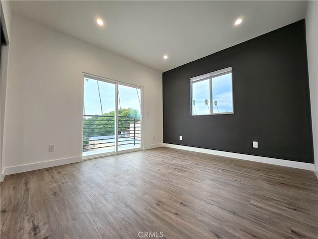 unfurnished room with hardwood / wood-style floors